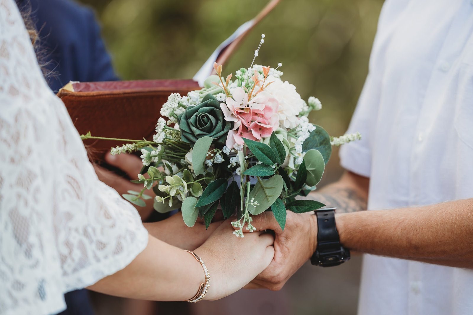 A bridal bouquet by Leisa handed over at a ceremony