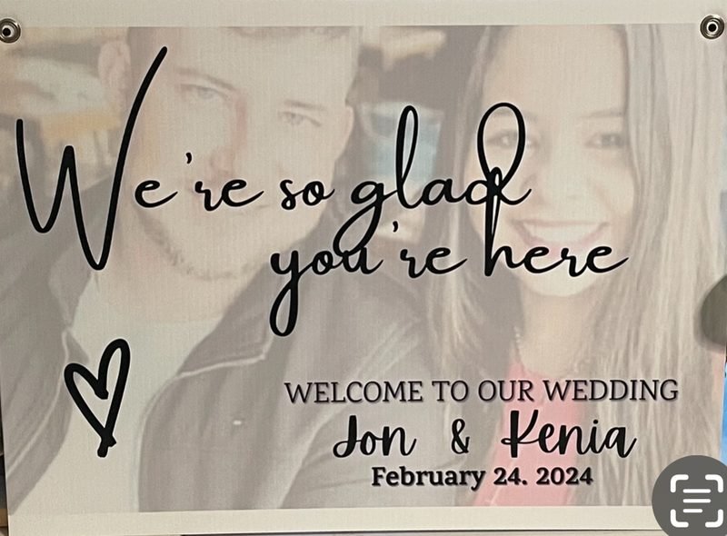 “We’re so glad you’re here” sign